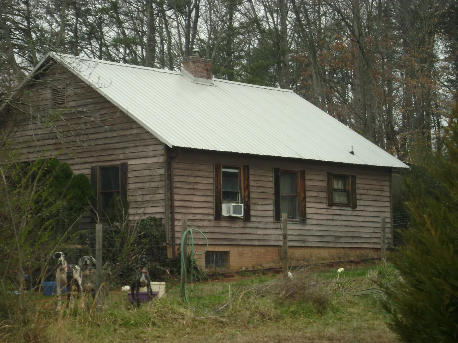 White metal roof on an old wood sided farmhouse, from a Metal Roof Installation job in North Haven